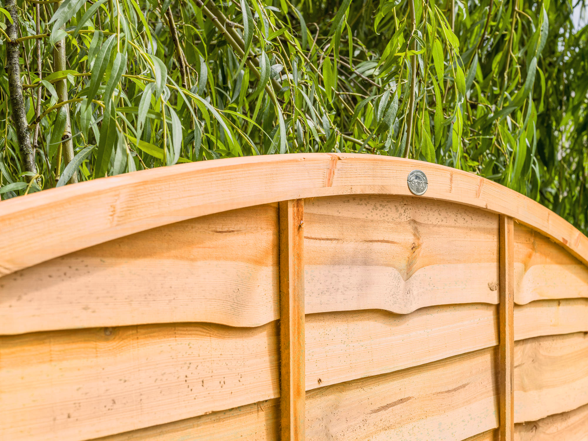 SUPERIOR BOW TOP LAP FENCE PANEL An added twist to a simple design, a stronger lap panel constructed using double waney edge slats that are secured into a neat arched shaped rebated frame.