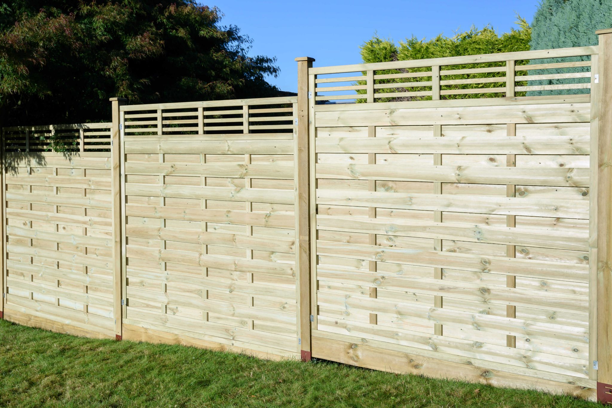 Featuring straight cut slats and a horizontal-style trellis top, the Elite Lille panel from Grange Fencing has been pressure-treated for long-lasting use. 